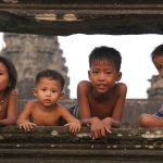 Kids pose in the Angor Wat temple in Cambodia. Photo by Pete Bracey