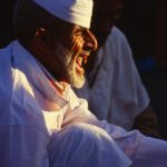 An Imman sings at prayer time in the Jemaa Al Fna in Marrakesh, Morroco. Photo by Pete Bracey