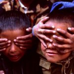 Sisters play with their brothers in a shop on the Annapurna Circuit in Nepal. Photo by Pete Bracey